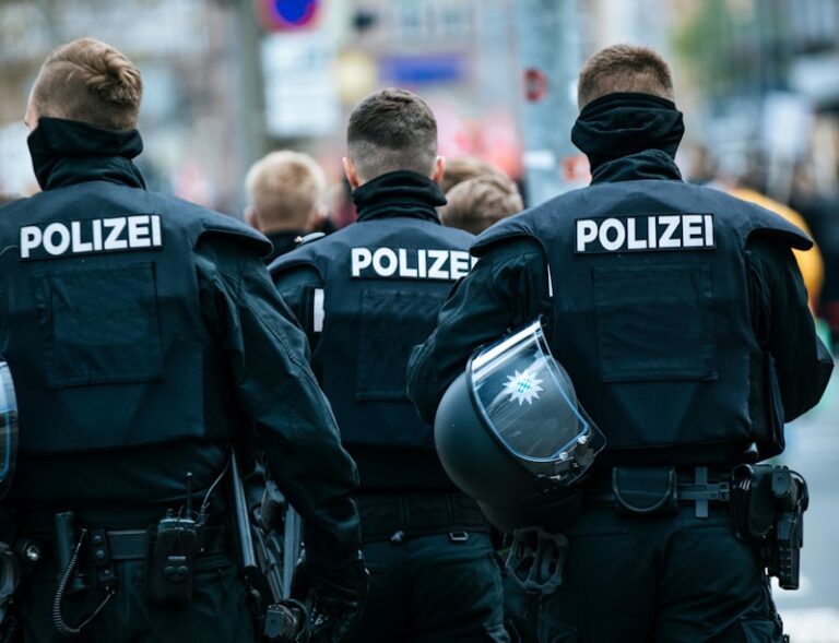police men in black and blue police uniform standing on street during daytime