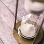 an hourglass sitting on top of a wooden table