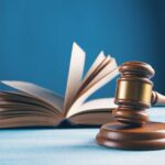 judges gavel and open book on table